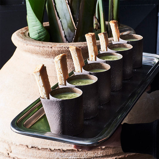 Handmade stoneware cups served on a tray at a restaurant, showcasing Doppiocotto's wholesale hospitality ceramics
