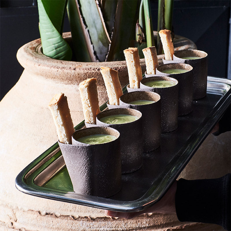 Handmade stoneware cups served on a tray at a restaurant, showcasing Doppiocotto's wholesale hospitality ceramics