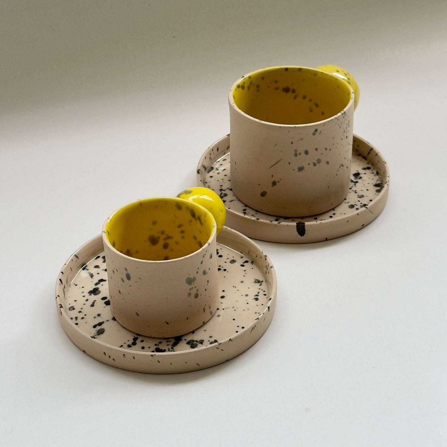 Artisan stoneware cup featuring a unique ball handle design