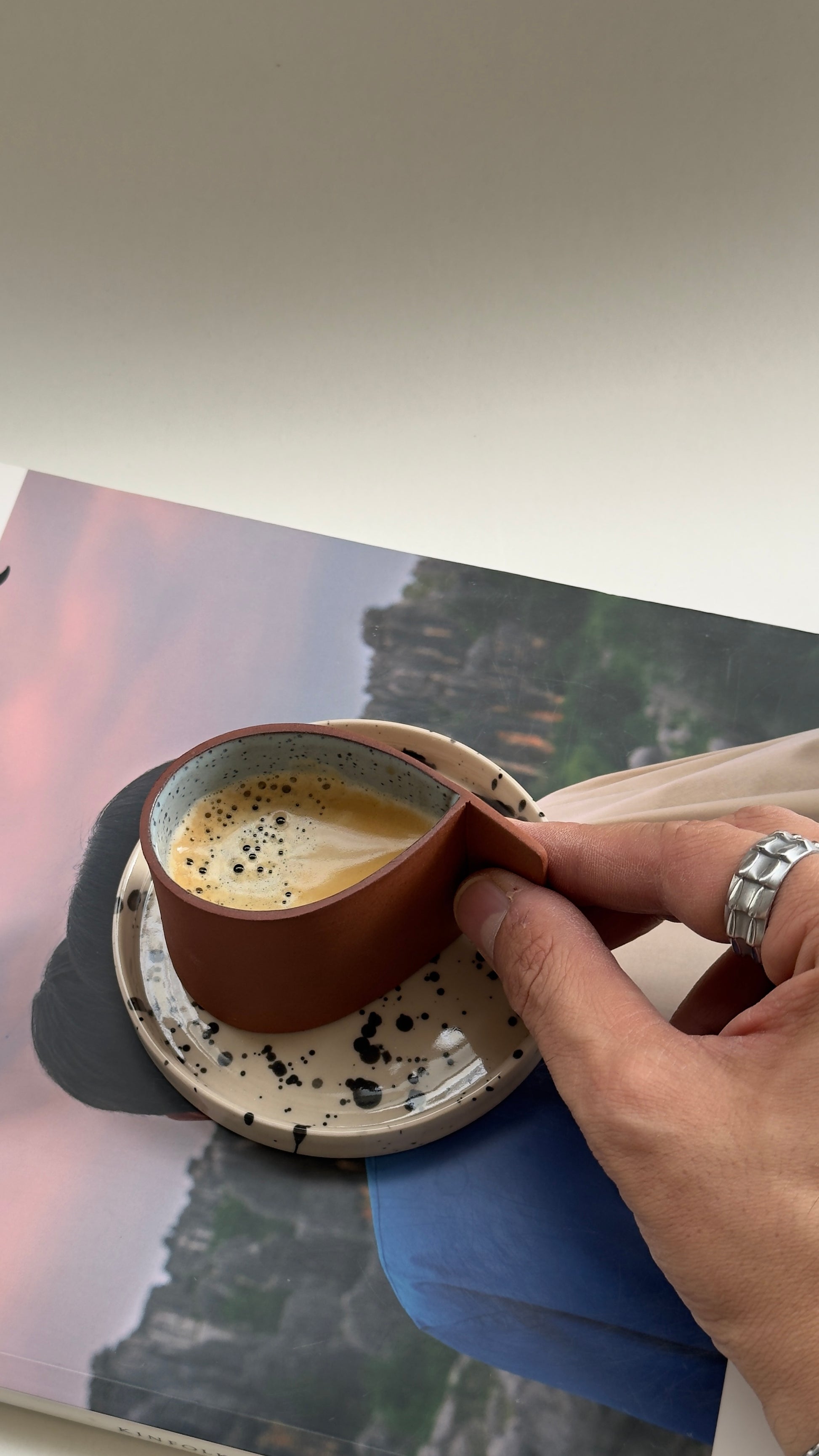 Artisan terracotta espresso cup and beige saucer for daily coffee rituals