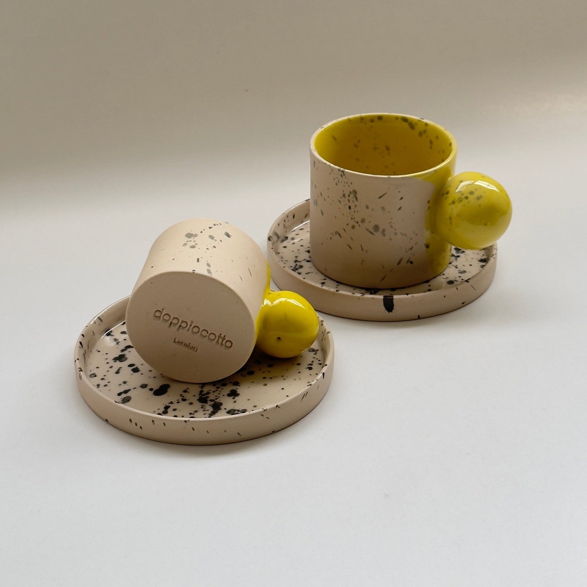Beige green handmade ceramic coffee cup with matching saucer