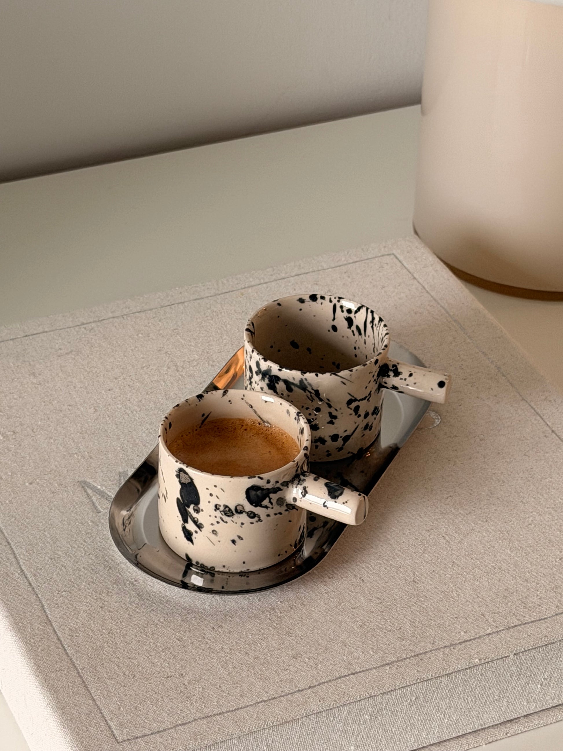 Set of two handmade black splash stoneware espresso cups