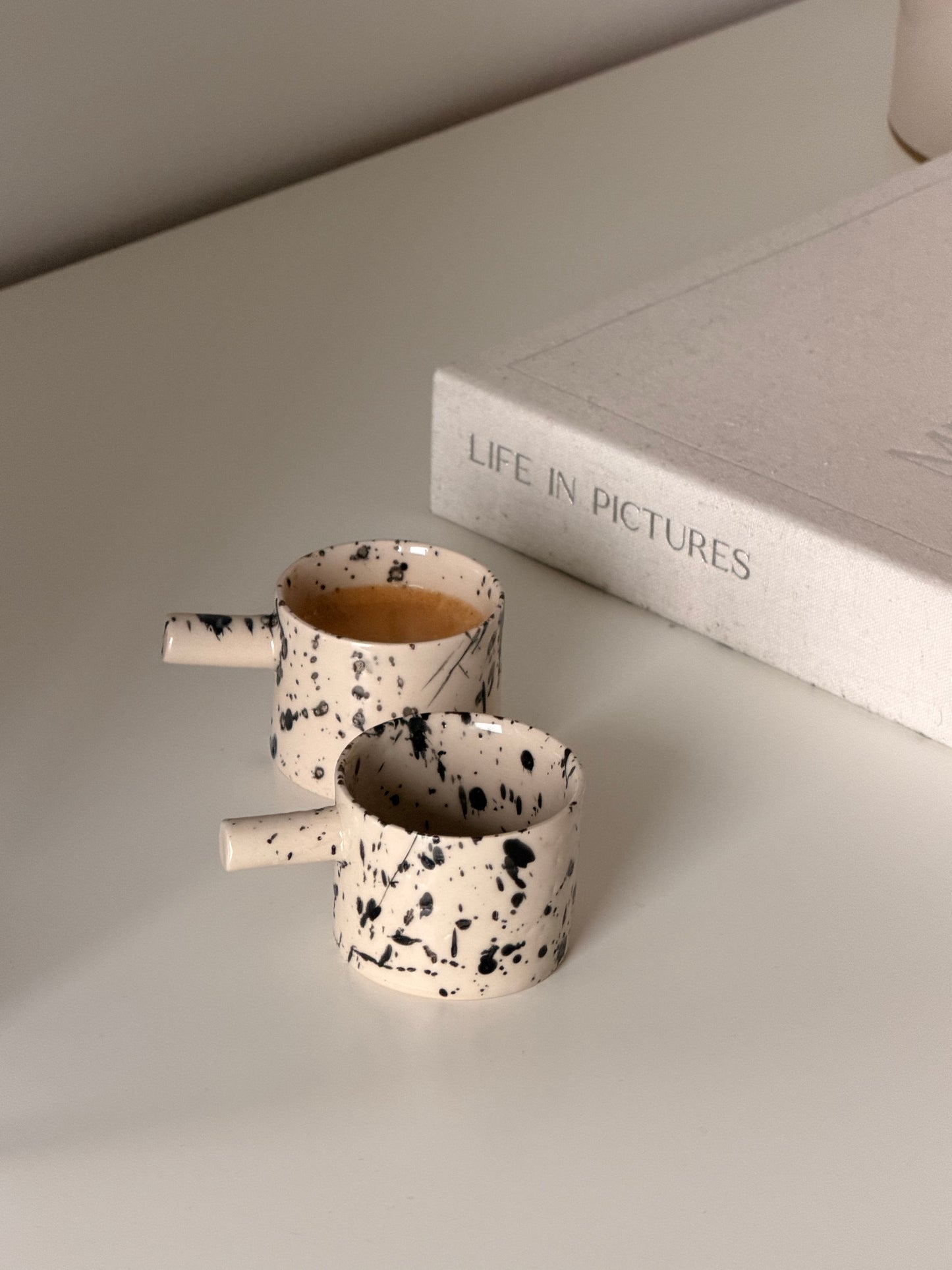 Small batch ceramic espresso cup set styled with coffee