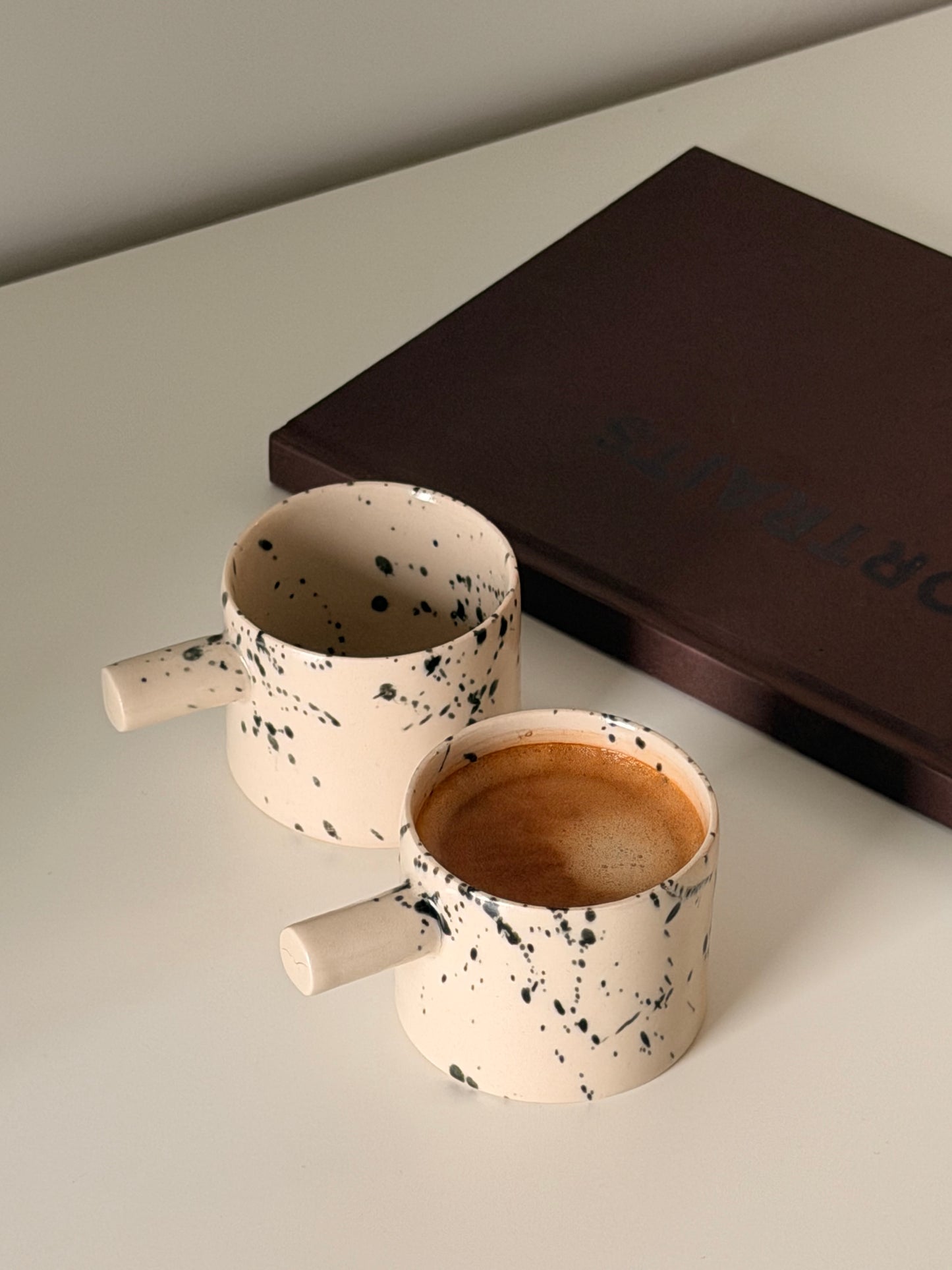 Detail of handmade stoneware espresso cup texture and glaze