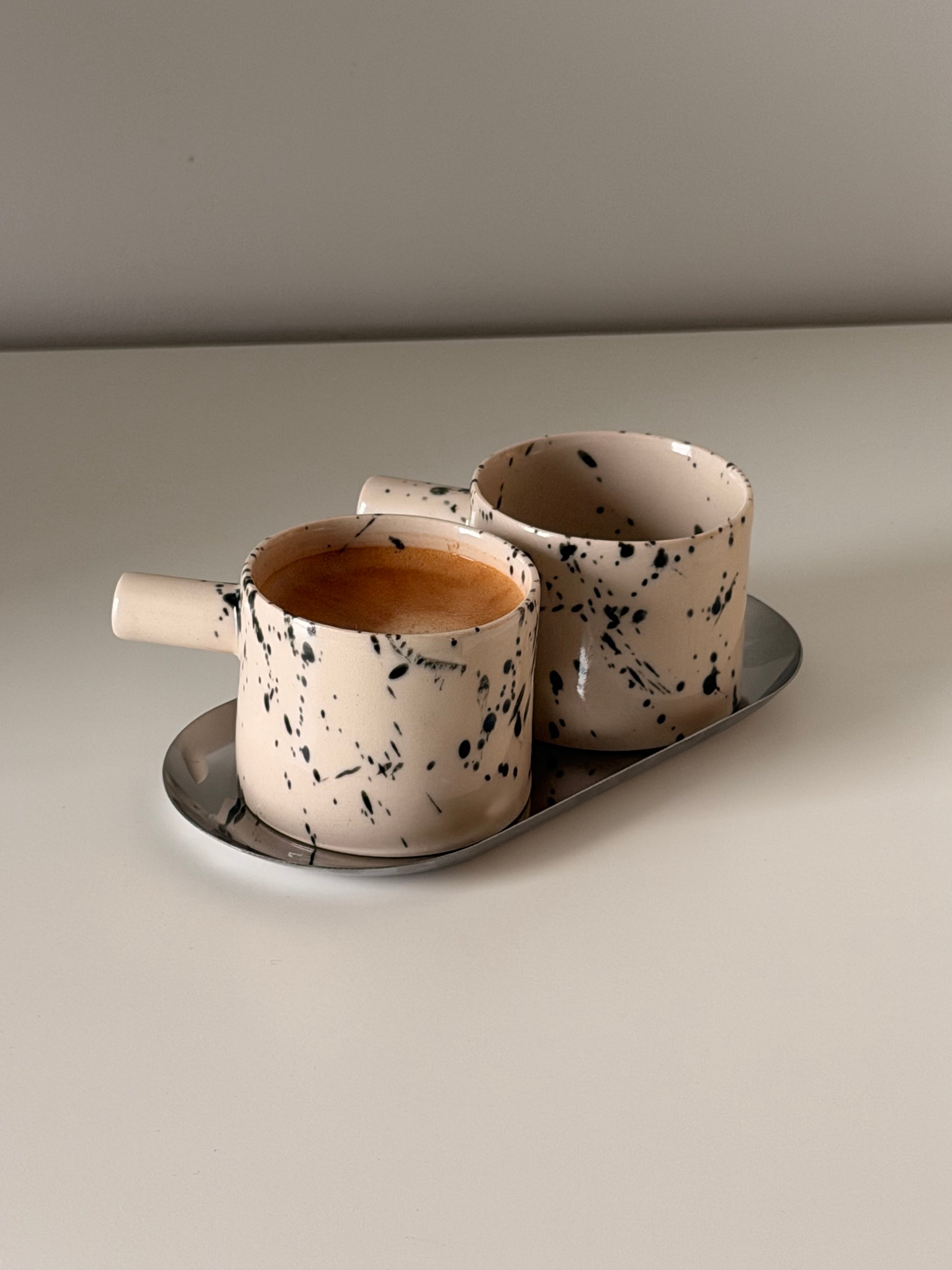 Close up of handmade speckled ceramic espresso cups
