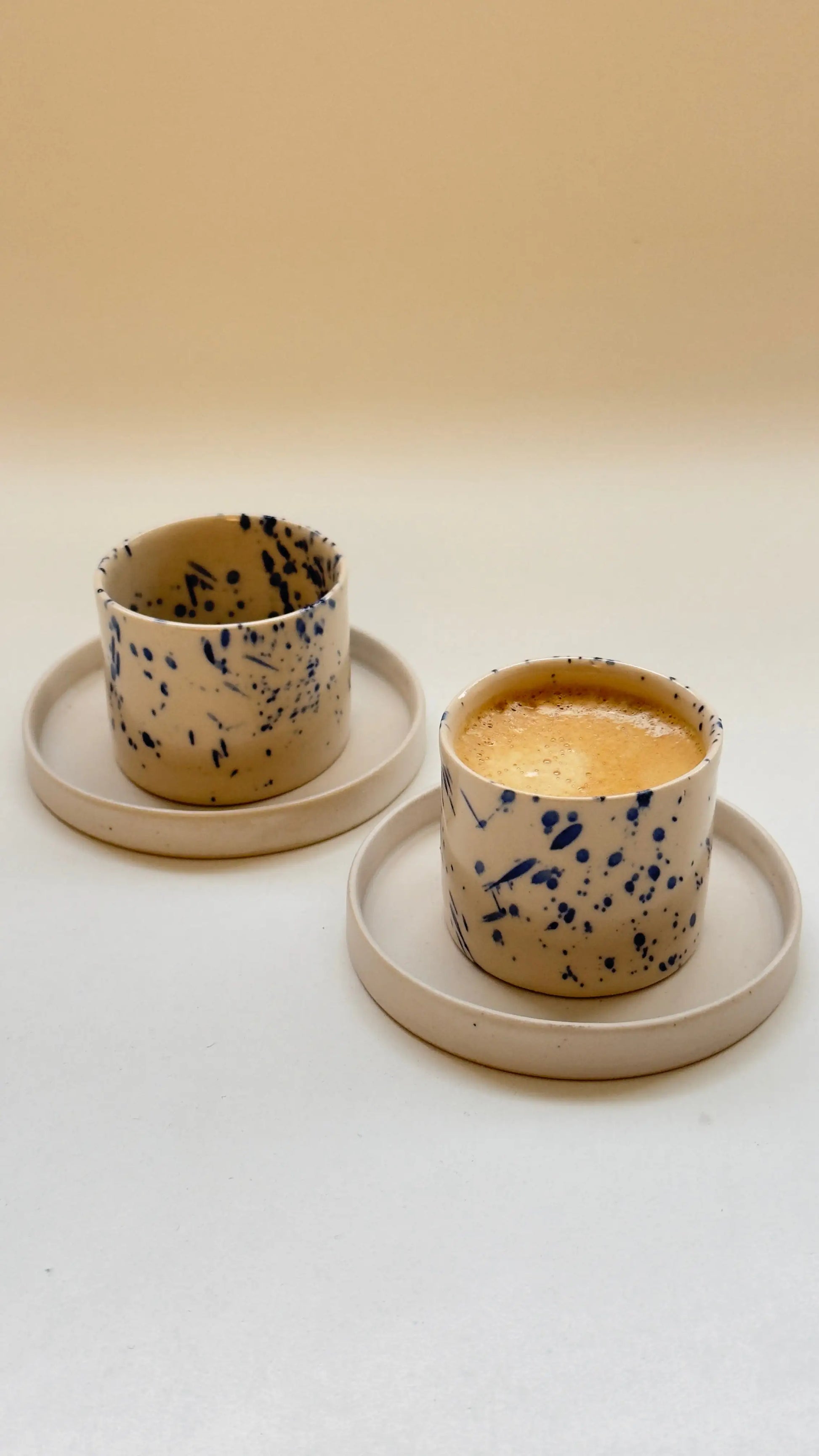Handmade handleless espresso cup and saucer set with speckled glaze
