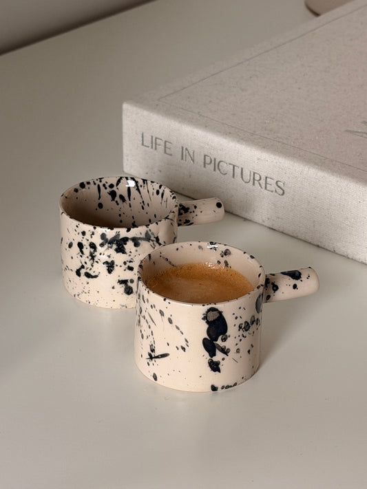 Set of two handmade black splash stoneware espresso cups