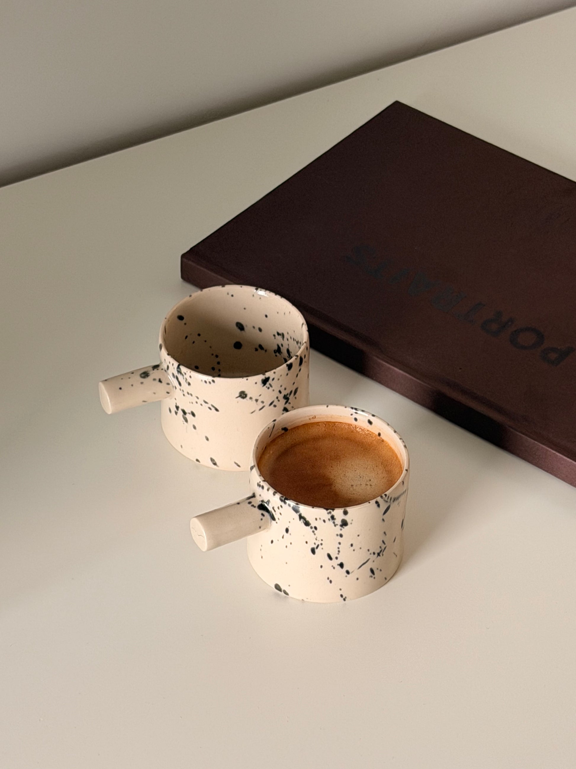 Minimalist handmade ceramic coffee cups with speckled finish