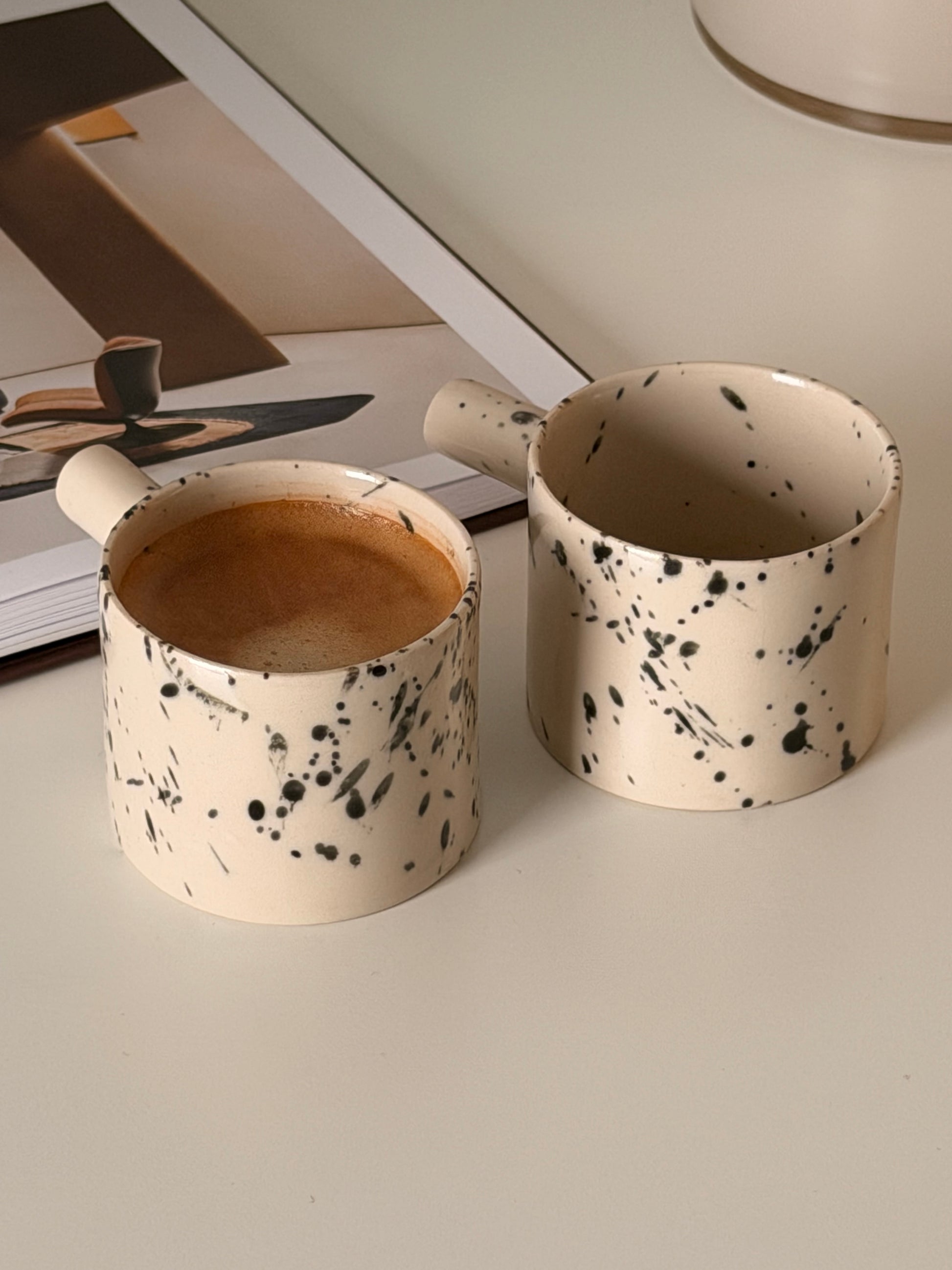 Close view of speckled glaze on handmade espresso cups