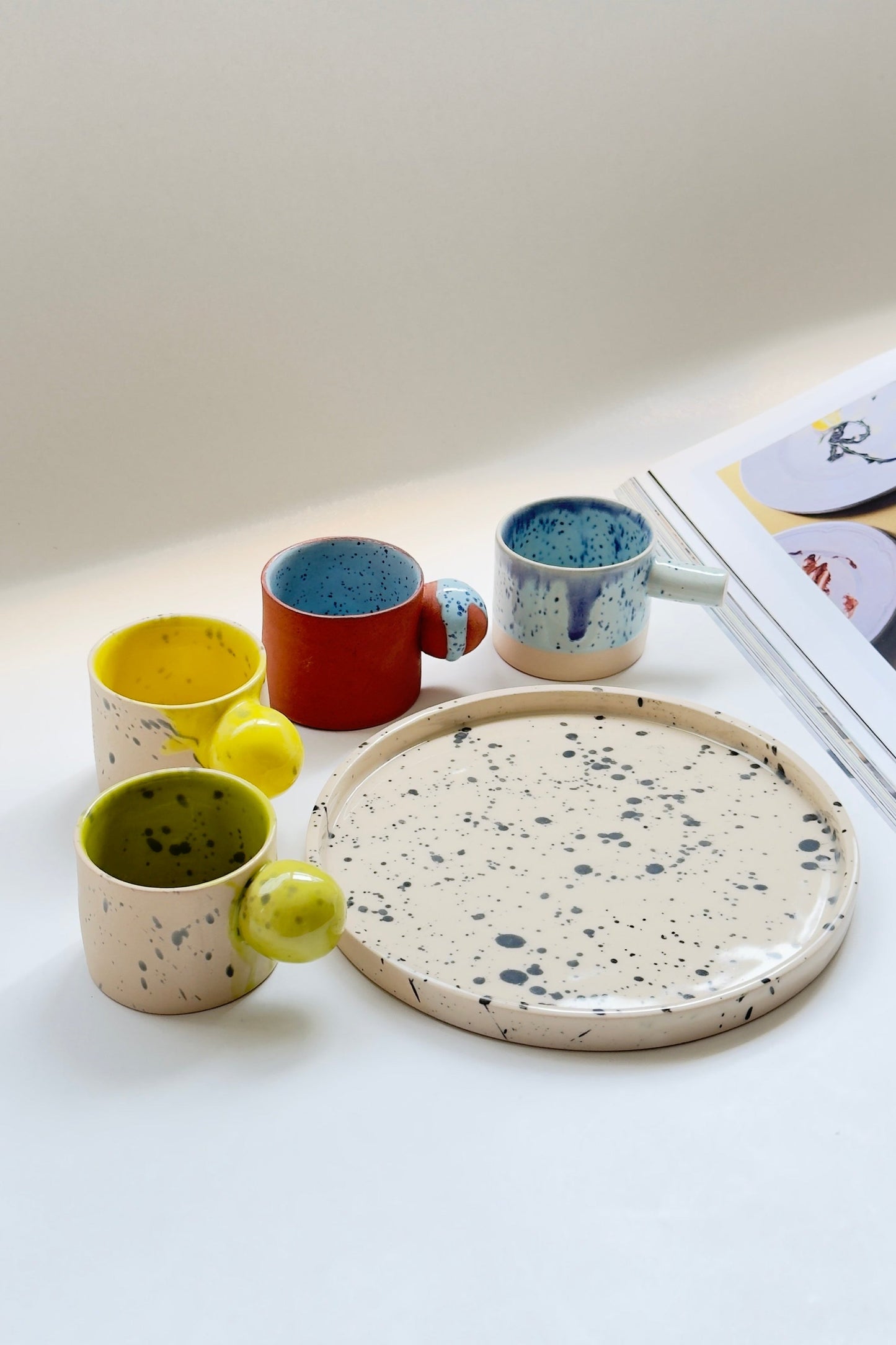 Handcrafted stoneware espresso cups with vibrant glaze details